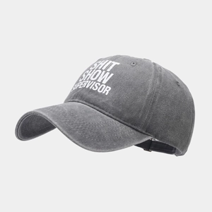 Detail of washed grey cotton baseball cap featuring white 'SHIT SHOW SUPERVISOR' slogan print