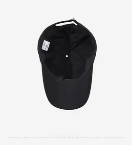 Detail view of the 100% cotton inner lining and adjustable label on a black baseball cap