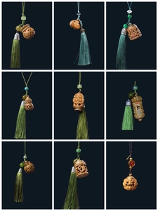 Detail showing carved wooden pendants with green tassels and traditional Chinese symbols