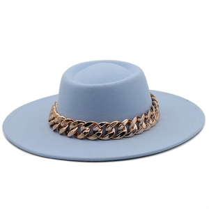 Light blue flat top wool felt hat with chunky rose gold chain detail on white background