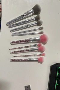 Detail view of 10 crystal handle makeup brushes with pink and grey soft bristles