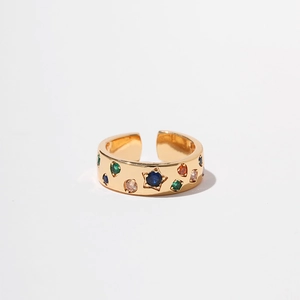 Close-up of golden bow ring featuring multi-colored star and round zircon stones