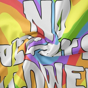 Close-up of bohemian tapestry fabric with rainbow print and graffiti style text