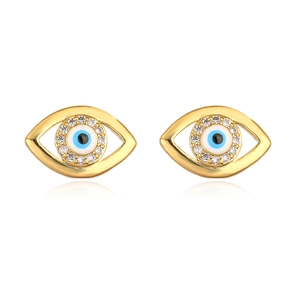 Detail of gold evil eye stud earrings with blue enamel and sparkling zircon crystals