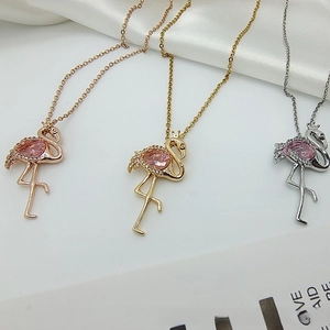 Detailed close-up of flamingo pendants in rose gold, gold and silver with pink zircon