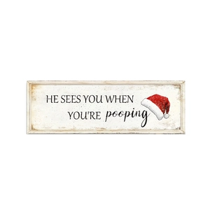 Detail of wooden Christmas sign featuring funny quote and festive Santa hat illustration