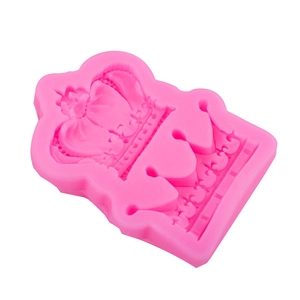 Pink crown silicone mold for cake fondant and chocolate making on white background