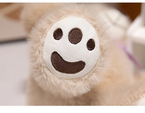 Macro detail of cute teddy bear plush paw with brown embroidered smile pattern