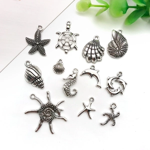 Macro view of ocean series charms including starfish and shells in antique silver alloy