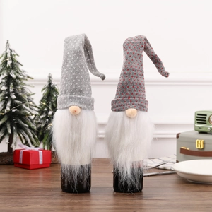 Detail of Christmas gnome wine bottle covers with gray knit hats and faux fur beards