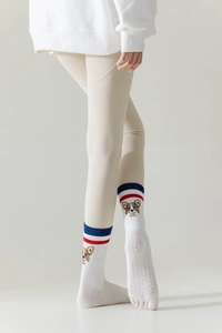 Close-up of white yoga toe socks with corgi embroidery and anti-slip silicone dots