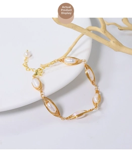 Detail of handmade wire-wrapped natural pearl bracelet with gold metal weaving and clasp