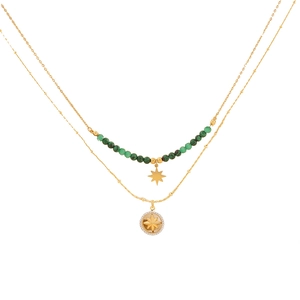 Double-layer gold necklace featuring emerald green beads and a starry compass pendant