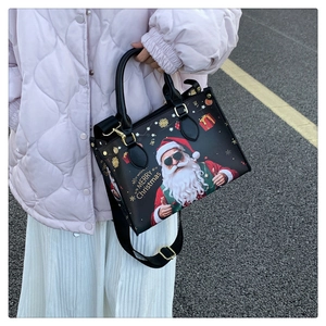 Outdoor shot of Santa Claus tote bag with Merry Christmas print and shoulder strap