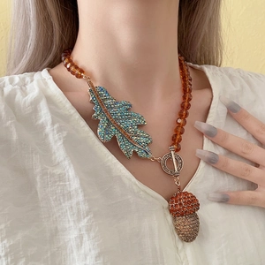 Vintage leaf and acorn pendant necklace with amber beads and blue-green gradient crystals