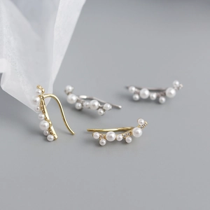 Detailed view of s925 silver branch earrings with faux pearls and sparkling zircon accents