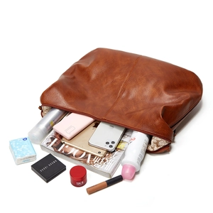 Top view showing large capacity of the brown tote bag with tablets and cosmetics