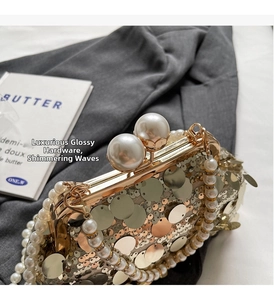 Detailed top view of champagne sequin clutch with large pearl clasp and pearl strap