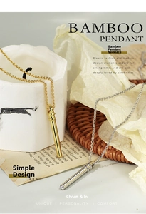 Detail of minimalist bamboo pendant necklace with polished finish on a luxury background