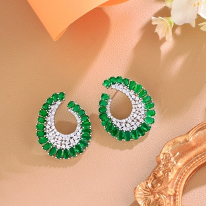 Elegant silver C-shaped earrings with green oval gemstones and micro-paved cubic zirconia