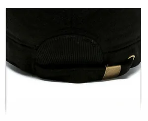 Detail of adjustable metal buckle and strap on the back of a black flat top winter cap