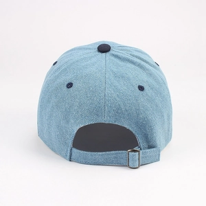 Close-up of denim baseball cap back featuring an adjustable metal buckle and ventilation eyelets