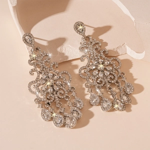 Detailed macro view of luxury teardrop tassel earrings with sparkling rhinestones and silver pins