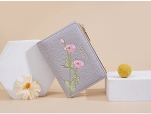 Detail of floral embroidery on purple PU leather short wallet with Baellerry logo