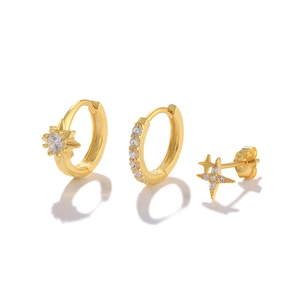 Detailed view of 3-piece gold sterling silver earring set with stars and clear crystals