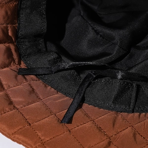 Quilted caramel brown bucket hat featuring a diamond stitch pattern and adjustable drawcord