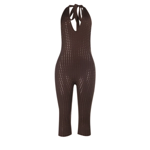 Close-up of deep V-neck halter jumpsuit featuring shiny silver sequins on brown fabric