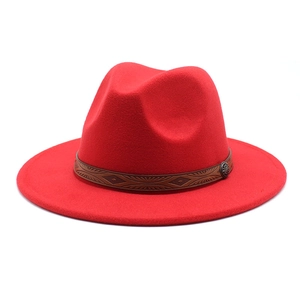 Detail of red wool fedora hat featuring a brown embossed leather band and vintage metal buckle