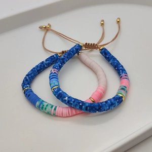 Detail of bohemian hand-woven bracelets with colorful clay beads and natural pearls