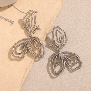 Macro shot of silver abstract hollow-out line earrings with polished metal finish