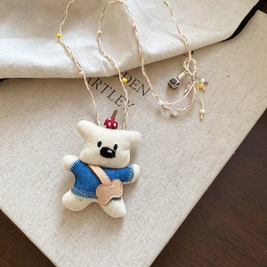 Handmade plush bear pendant necklace with woven cord and colorful bead accents