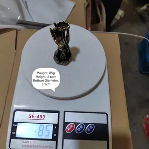 Macro shot of brass buddha hand incense burner showing 85g weight and 6.6cm height
