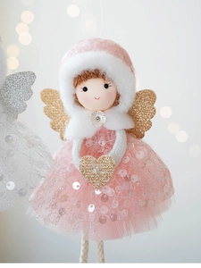 Close-up of pink mesh Christmas angel ornament with gold wings and sequin details