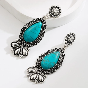 Bohemian turquoise teardrop earrings with vintage silver floral metal detailing