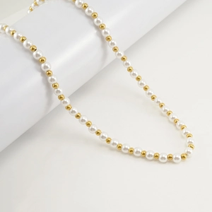 Elegant gold-tone stainless steel chain necklace with alternating white pearls on white background