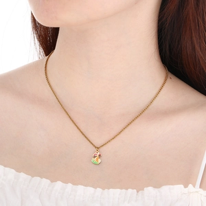 Detail shot of a model wearing a gold mushroom necklace with colorful enamel charm