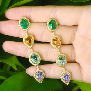 Detail of colorful waterdrop gemstone long tassel earrings with sparkling rhinestones