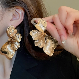 Retro vintage golden metal flower earrings featuring a large 3D floral petal design