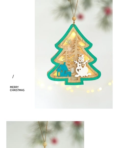 Close-up of wooden Christmas tree ornament with LED light and cutout snowman design