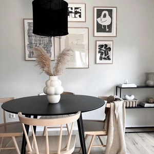 Nordic minimalist bubble ceramic vase on black wood table with abstract art in white finish