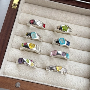 Detailed view of S925 sterling silver rings with colorful heart and star shaped gemstones