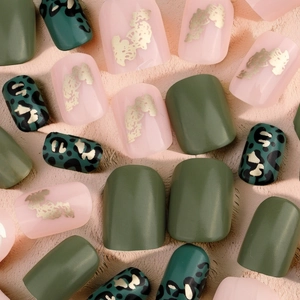 Short square press-on nails in green and pink with gold foil flakes and leopard design
