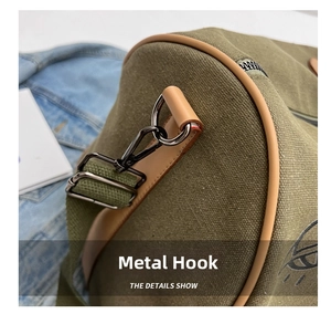Detail showing high-strength metal hook and leather edging on green canvas travel bag