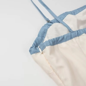 Detail of invisible side zipper and adjustable spaghetti straps on cream floral dress