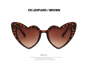 Detailed front view of leopard print heart sunglasses with gradient brown lenses