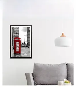 Modern black wooden frame showcasing London street art in a minimalist living room setting